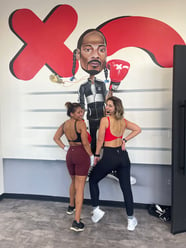 Rumble Boxing Fort Lauderdale Member Steffi Poses with Trainer